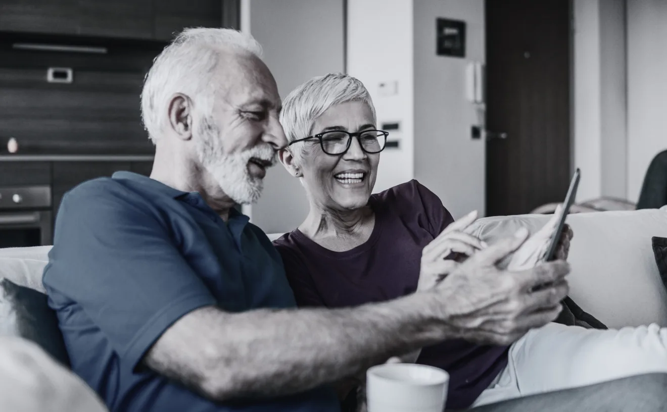 Elderly couple using a tablet together, representing digital cognitive health support